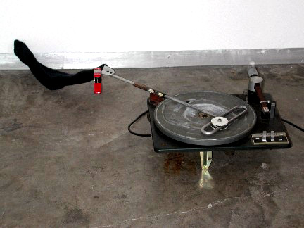 Disc Plate 
2005
Record player parts, mechanical parts, transformer, motion sensor, sock
6 x 19 x 44 inches
Unique