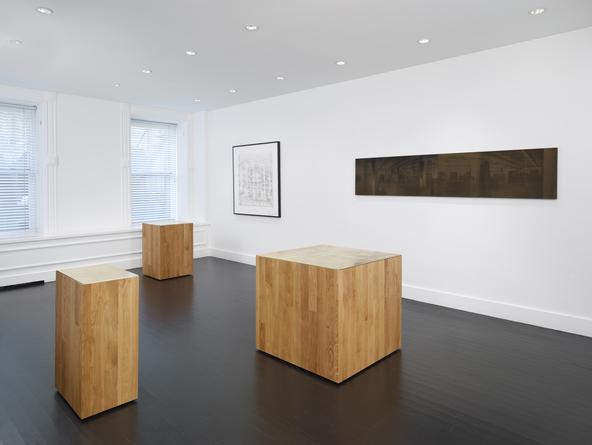 Installation view: Three new buildings, a fence and a factory.
