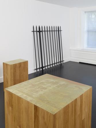 Installation view: Three new buildings, a fence and a factory.