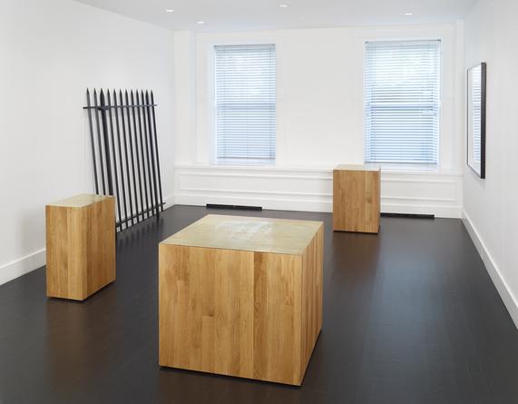 Installation view: Three new buildings, a fence and a factory.