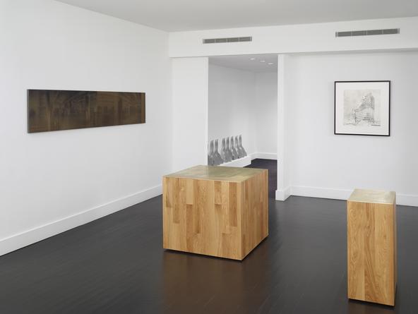 Installation view: Three new buildings, a fence and a factory.